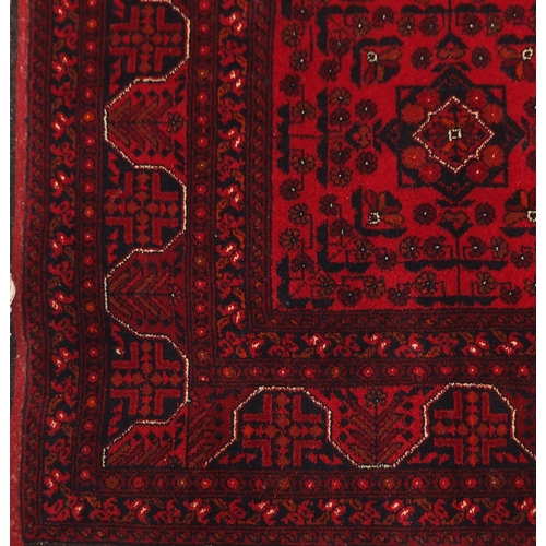 2033 - Rectangular Afghan red ground carpet, 202cm x 152cm