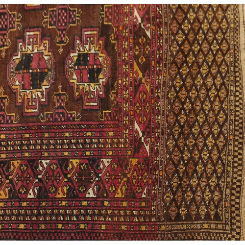 2063 - Rectangular Turkmen red ground rug, 230cm x 154cm