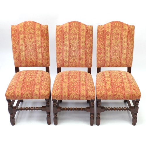 2020 - Set of six oak framed dining chairs with bobbin turned legs, having red and gold geometric upholster... 