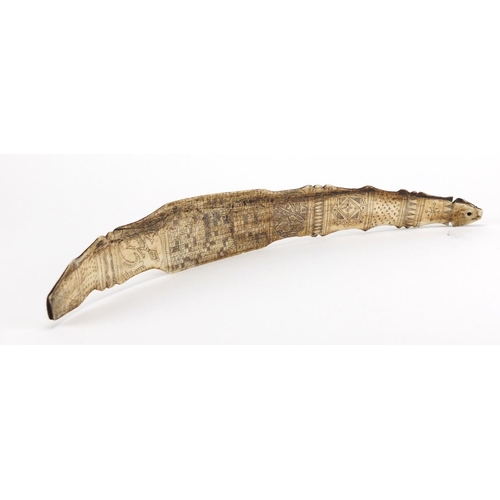 2545 - Scrimshaw style bone section carved with creatures and symbols, 39.5cm in length