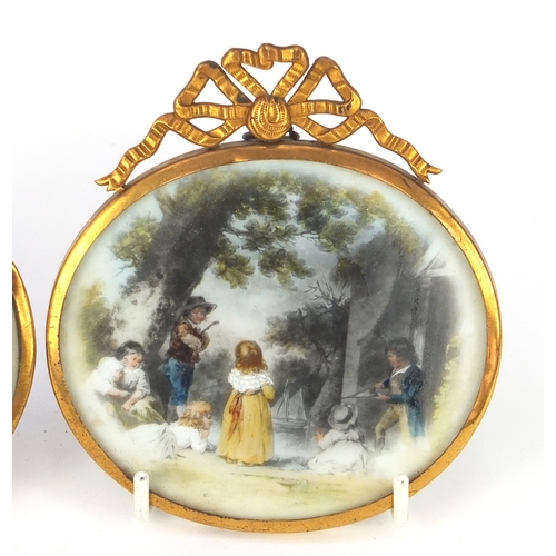 2549 - Pair of oval portrait miniatures housed in gilt frames, each depicting children at play, each miniat... 