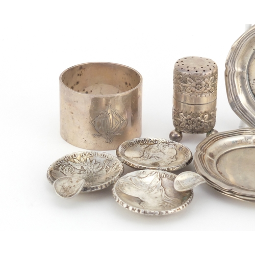 2601 - Silver objects comprising napkin ring, miniature caster, five dishes and a Maria Theresa Thaler ash ... 