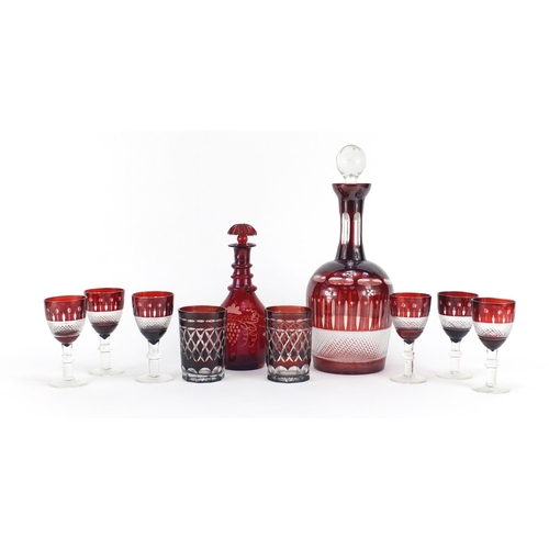 224 - Bohemian red flashed cut glassware including a decanter with six glasses, the largest 31cm high