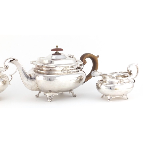 62 - Silver plated three piece tea service, the teapot with wooden handle and knop, 30cm in length