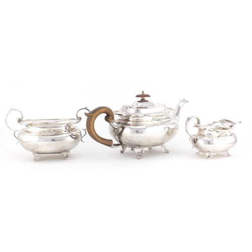 62 - Silver plated three piece tea service, the teapot with wooden handle and knop, 30cm in length
