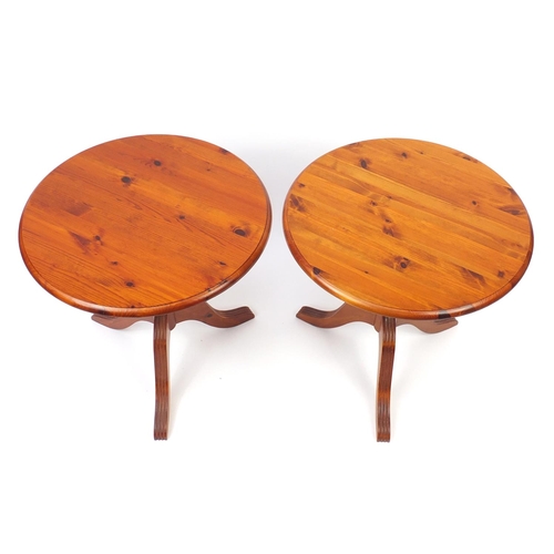 55 - Pair of circular pine occasional tables with tripod bases, 61cm high x 48cm in diameter