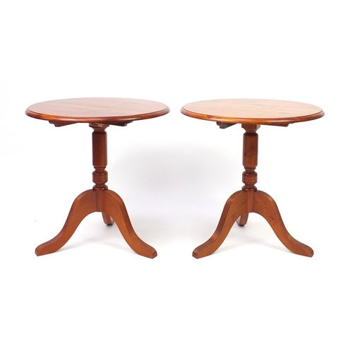 55 - Pair of circular pine occasional tables with tripod bases, 61cm high x 48cm in diameter