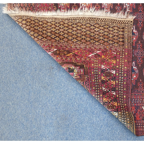 2063 - Rectangular Turkmen red ground rug, 230cm x 154cm