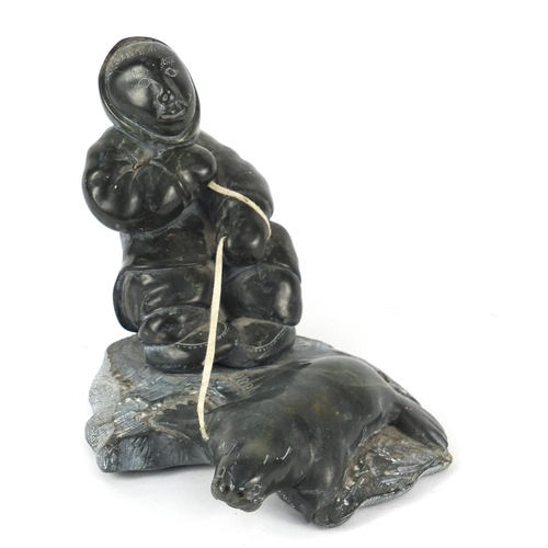 112 - Canadian Inuit stone carving of a eskimo and seal, 12cm high