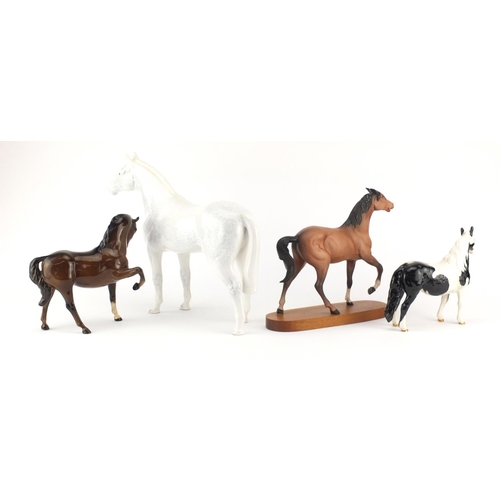 2213 - Three Beswick horses and one Sylvac including a black and white Pinto pony, the largest 29cm high