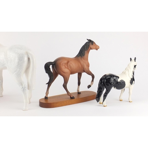 2213 - Three Beswick horses and one Sylvac including a black and white Pinto pony, the largest 29cm high