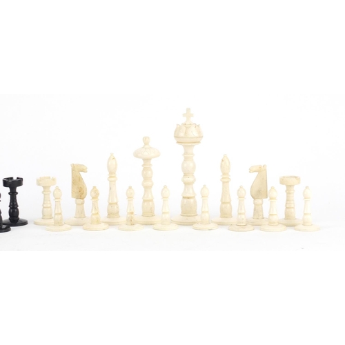376 - 19th century carved bone half stained chess set, the largest piece 11cm high