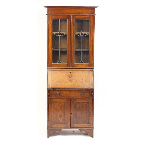13 - Arts & Crafts oak bureau bookcase with a pair of leaded stained glass doors, 195cm H x 75cm W x 33cm... 