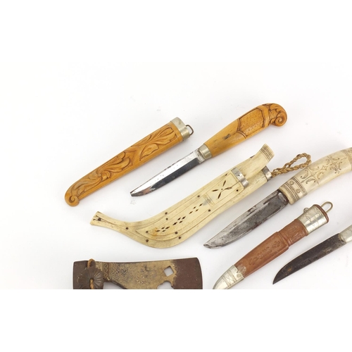 766 - Three hunting daggers and an axe head, one with bone sheath