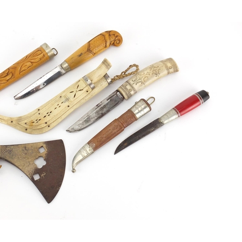 766 - Three hunting daggers and an axe head, one with bone sheath