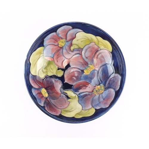 2114 - Moorcroft pottery footed bowl hand painted in the hibiscus pattern, 21.5cm in diameter