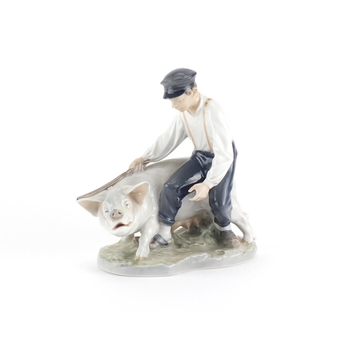 2111 - Royal Copenhagen figure of a boy, with a pig, number 848, 18.5 cm high