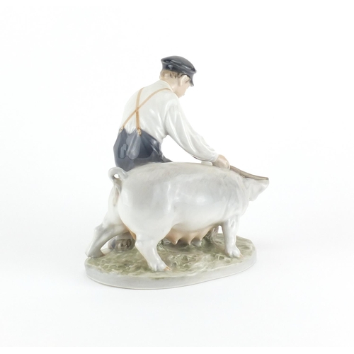2111 - Royal Copenhagen figure of a boy, with a pig, number 848, 18.5 cm high