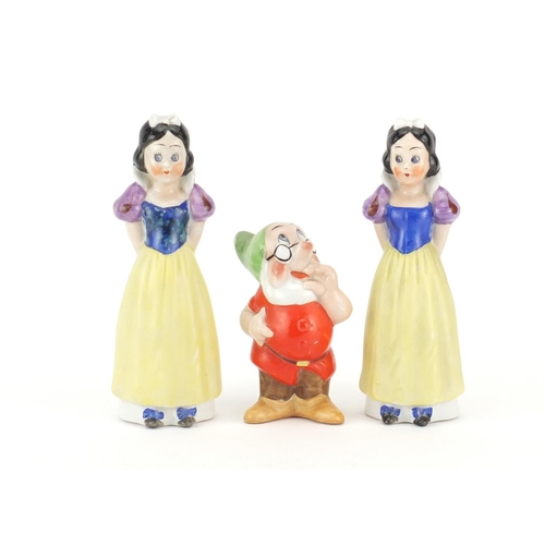 2123 - Three 1930's Walt Disney toothbrush holders comprising two Snow White and a Dwarf, two with paper la... 