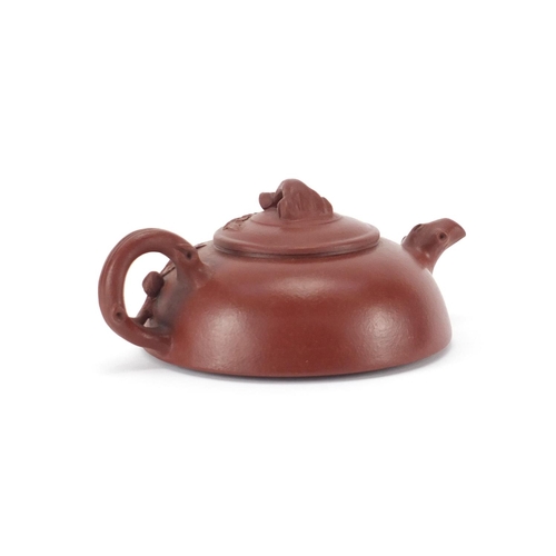 2085 - Chinese yixing terracotta squatted teapot with naturalistic handle and spout, impressed marks to the... 