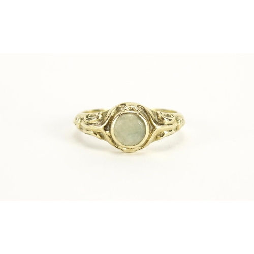 2372 - 9ct gold jade ring with scrolled shoulders, size O, 3.0g