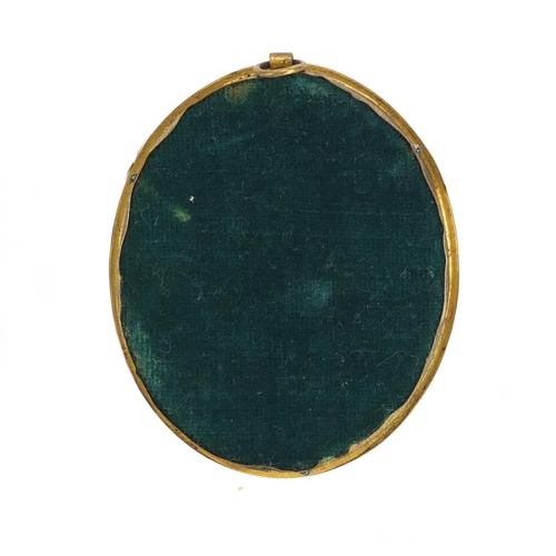 2339 - Oval portrait miniature of a young red headed girl, housed in a gilt metal pendant mount, the miniat... 