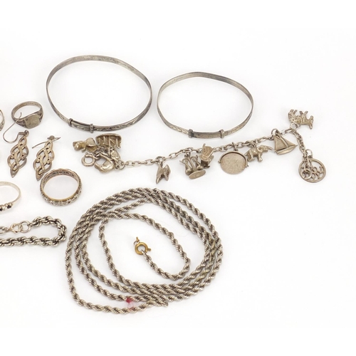 2447 - Silver and white metal jewellery including charm bracelet, bangles and rings, 168.5g