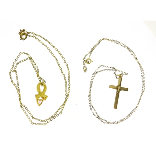 2437 - 9ct gold crucifix pendant and one other, both on gold coloured metal necklaces