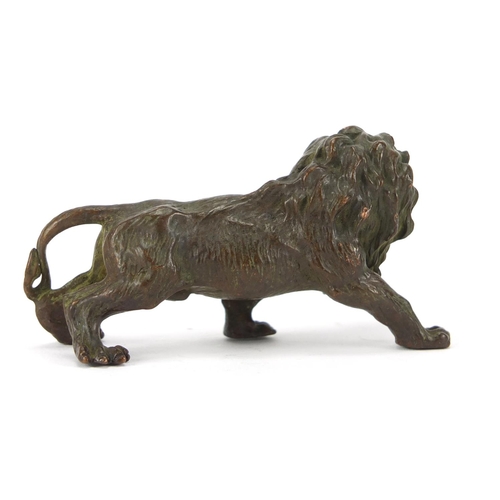 2284 - Japanese patinated bronze lion, impressed marks to the underside, 8cm in length