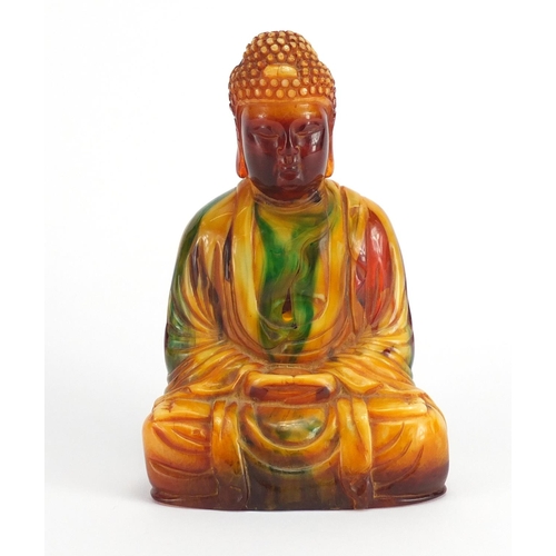 2122 - Butterscotch and cherry figure of a Tibetan Buddha, 15cm high