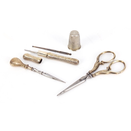 52 - 19th century French ebonised necessaire housing silver gilt implements including scissors, needle ca... 