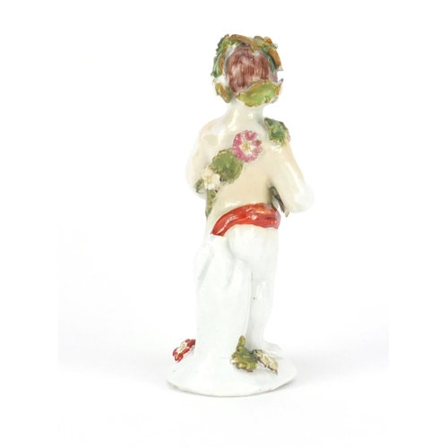 758 - 18th century Bow hand painted figure of putti holding flowers, 12.5cm high