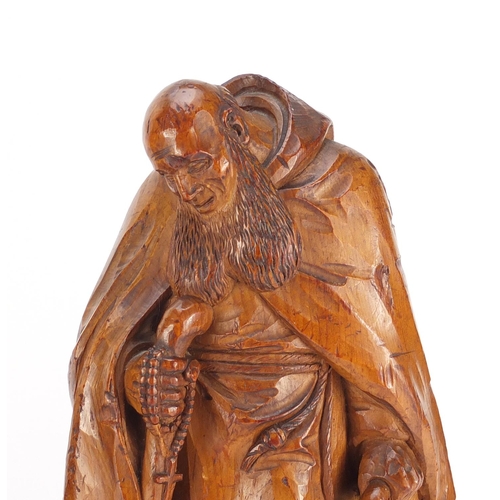 27 - Two 19th century continental wood carvings of monks, the largest 32.5cm high