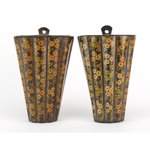704 - Pair of Kashmir papier-mâché lacquered wall pockets, decorated with flowers, each 17cm high