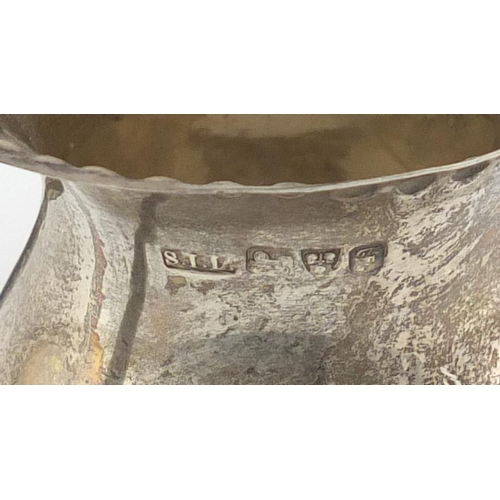 944 - Two octagonal silver baluster shaped casters and a pedestal milk jug, various hallmarks, the largest... 