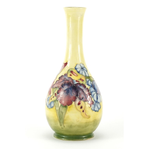 817 - Moorcroft pottery vase hand painted in the Yellow Orchid pattern, impressed marks and paper label to... 
