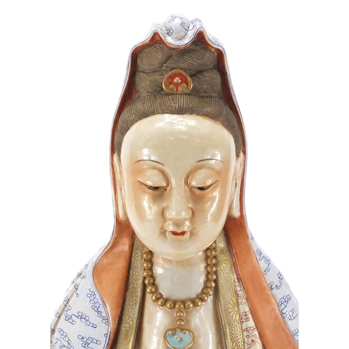 394 - Large Chinese porcelain figure of Guanyin wearing a robe and holding a scroll, finely hand painted w... 