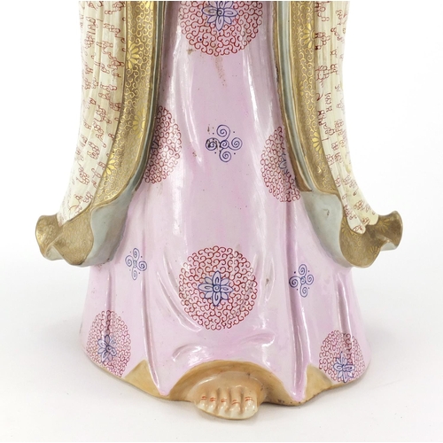 394 - Large Chinese porcelain figure of Guanyin wearing a robe and holding a scroll, finely hand painted w... 