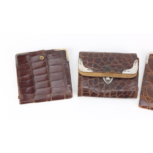 56 - Four crocodile skin effect leather wallets and purses, one with 9ct gold mounts the others with silv... 