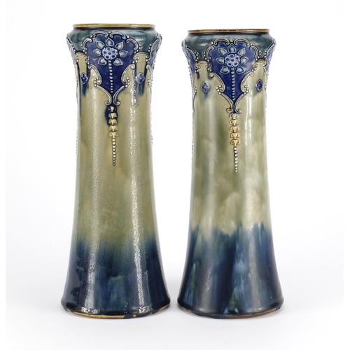 823 - Pair of Art Nouveau Royal Doulton vases, decorated in low relief with stylised flowers, impressed ma... 
