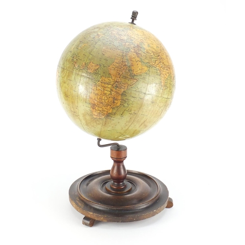 25 - Philips 12inch terrestrial globe raised on a stained mahogany base, 52cm high