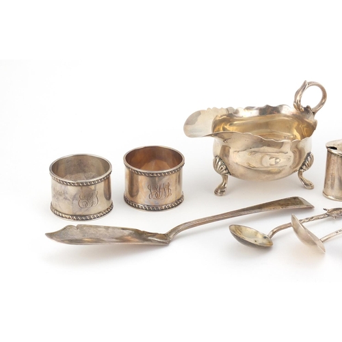 946 - Georgian and later silver objects including three footed sauce boat, three mustards with blue glass ... 