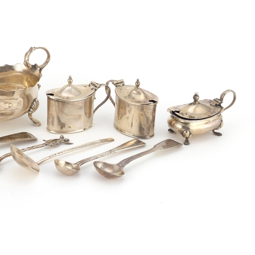 946 - Georgian and later silver objects including three footed sauce boat, three mustards with blue glass ... 