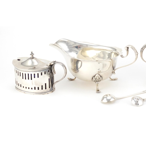 941 - Silver items including a pair of three footed sauce boats by Mappin & Webb and a mustard with blue g... 