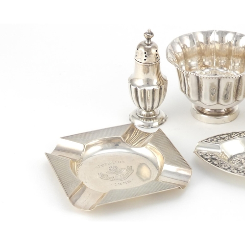 947 - Silver items including two circular bowls, a miniature tig trophy and two ashtrays, various hallmark... 