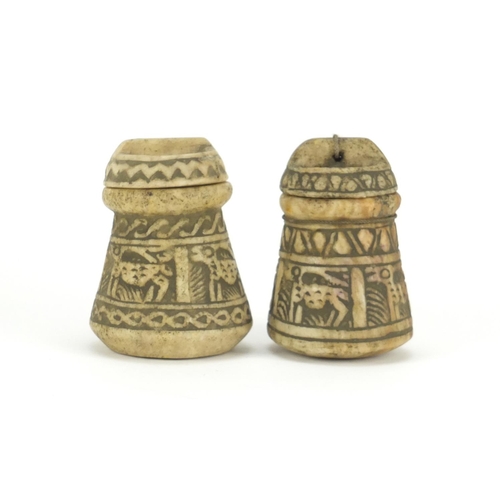 711 - Two Islamic stone pots with covers carved with animals, the largest 11cm high