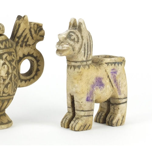 710 - Three Islamic carved stone oil lamps including two in the form of lions, the largest 13cm high