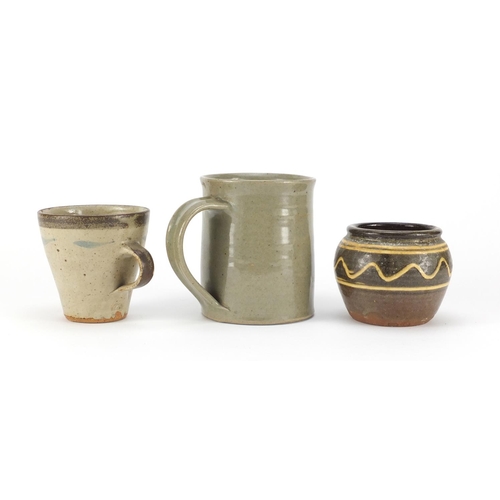 842 - Studio pottery comprising a John Leach Studio Pottery Bovey Tracy mug, Leach pottery mug and a Sydne... 