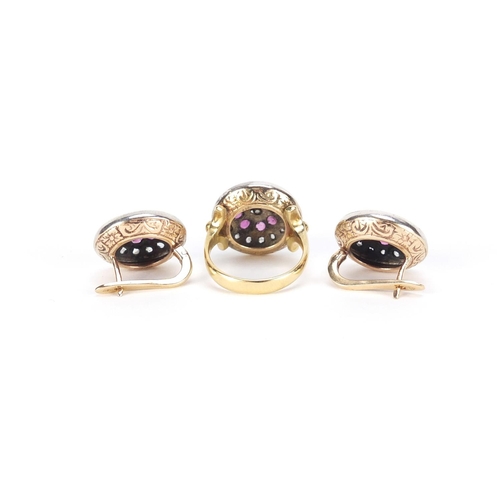 964 - 18ct gold ruby and diamond halo ring and a pair of matching earrings marked 500, the ring size N, 20... 