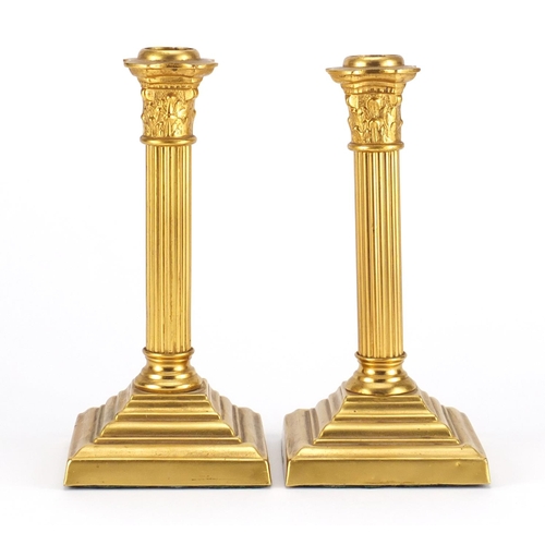 17 - Pair of 19th century gilt metal Corinthian column candlesticks, 20cm high